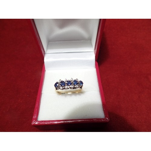 43 - 18CT GOLD DRESS RING SET WITH 5 ROUND CUT SAPPHIRES FLANKED BY 8 DIAMONDS - 3.6 GRAMS