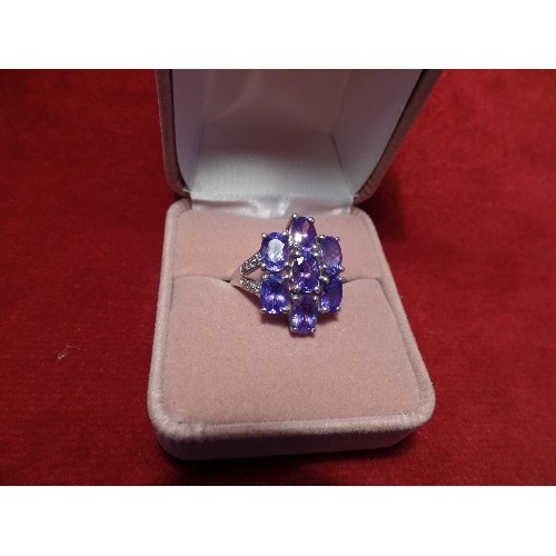 67 - A STUNNING 9CT WHITE GOLD COCKTAIL RING SET WITH 7 BEAUTIFUL TANZANITES FORMING A FLOWER, WITH DIAMO... 