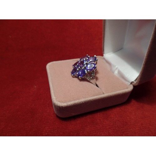 67 - A STUNNING 9CT WHITE GOLD COCKTAIL RING SET WITH 7 BEAUTIFUL TANZANITES FORMING A FLOWER, WITH DIAMO... 