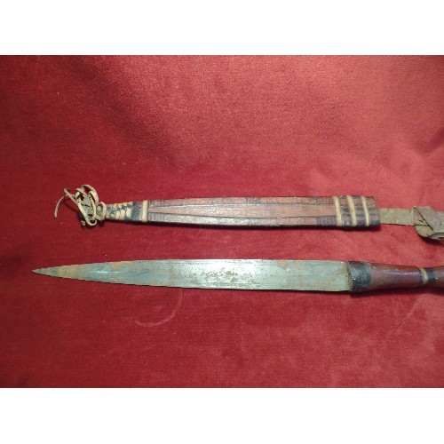 97 - A CIRCA 1930'S NIGERIAN ARM DAGGER WITH LEATHER COVERED HILT AND SCABBARD. PLAITED, TOOLED AND PAINT... 