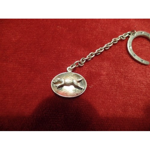 56G - A STERLING SILVER OVAL PENDANT OR CHARM WITH A RUNNING HOUND, BIRM 1966, COHEN AND CHARLES, ON A SIL... 