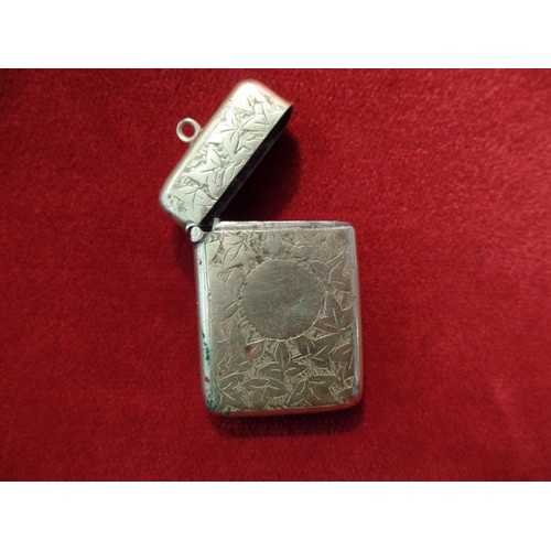 35J - A STERLING SILVER VESTA CASE ENGRAVED WITH FOLIATE DESIGN AND WITH BLANK SHIELD 23 GRAMS. BIRM 1910,... 