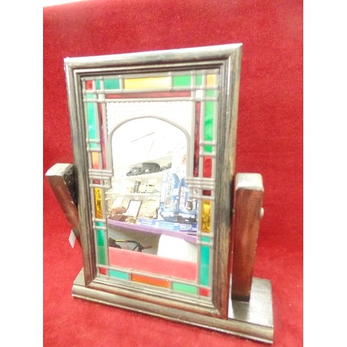 124 - SMALL DECORATIVE LEADED/COLOURED GLASS MIRROR ON WOODEN STAND.