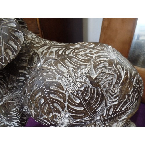 138 - VERY LARGE DECORATIVE INDIAN ELEPHANT. CARVED WITH UNUSUAL BANANA LEAF DESIGN. REPAIR TO EAR.