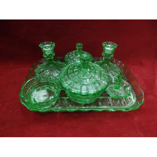 141 - EMERALD GREEN GLASS DRESSING TABLE SET. INCLUDES CANDLESTICKS, LIDDED POTS AND A RING TREE. TOGETHER... 