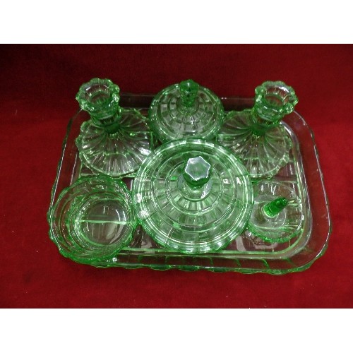 141 - EMERALD GREEN GLASS DRESSING TABLE SET. INCLUDES CANDLESTICKS, LIDDED POTS AND A RING TREE. TOGETHER... 