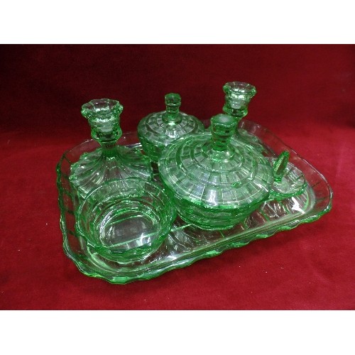 141 - EMERALD GREEN GLASS DRESSING TABLE SET. INCLUDES CANDLESTICKS, LIDDED POTS AND A RING TREE. TOGETHER... 