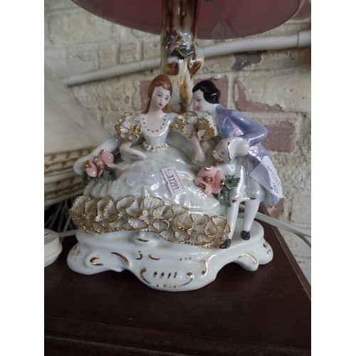 202 - 'ALEA JULIA -CORAL' SMALL DECORATIVE TABLE LAMP BASE WITH PORCELAIN FIGURES UNDER A TREE. PINK SHADE... 