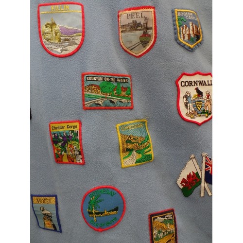 342 - FLEECE DOOR CURTAIN DECORATED WITH LARGE QUANTITY OF SEWN -ON CLOTH SOUVENIR BADGES FROM ALL OVER TH... 