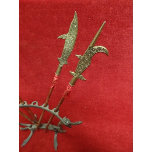 208 - SMALL DECORATIVE TRIBAL SPEARS ON A FRAME. 1 MISSING.