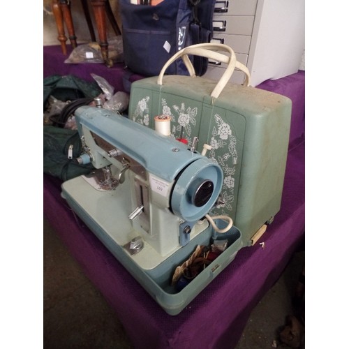 169 - RETRO JONES ELECTRIC SEWING MACHINE. 2-TONE. WITH FLORAL PLASTIC CASE.