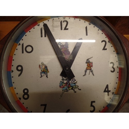 278 - HEAVY VINTAGE WALL CLOCK. 'PUL-SYN-ETIC IMPULSE CLOCK. DECORATED WITH KNIGHTS IN SHINING ARMOUR. HEA... 