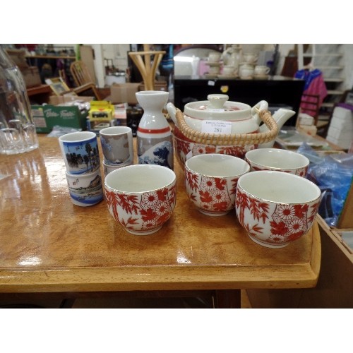 281 - JAPANESE TEA SET, TEAPOT WITH CANE HANDLE, & 4 CUPS. ALSO SMALL CARAFE & 4 TINY BEAKERS.