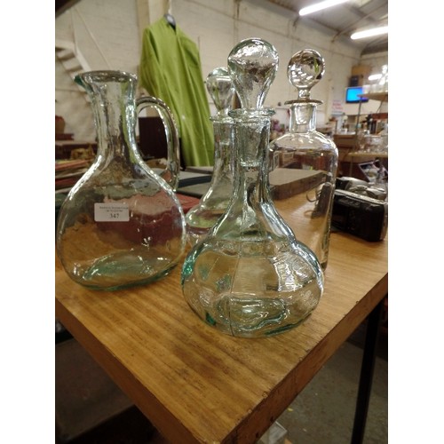 347 - PAIR OF PRESSED GLASS DECANTERS, A WATER JUG, AND A CONTEMPORARY DECANTER. WITH STOPPERS.