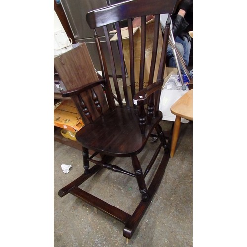 391 - POLISHED DARK WOOD WINDSOR ROCKING CHAIR. REPRO.