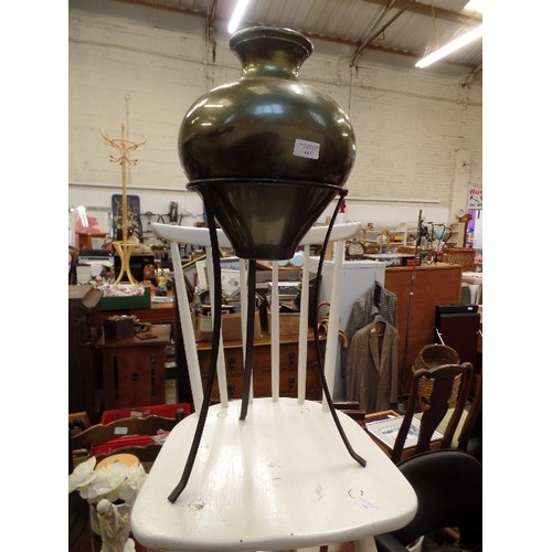 443 - METALLIC GREEN METAL URN ON BLACK WROUGHT IRON STAND.