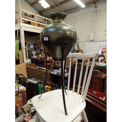 443 - METALLIC GREEN METAL URN ON BLACK WROUGHT IRON STAND.