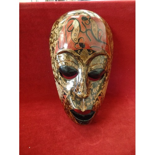 76 - DECORATED AFRICAN WOODEN MASK. LOVELY MUTED COLOURS, RUST, BROWN, BLACK. WALL HUNG. HIGH GLOSS.