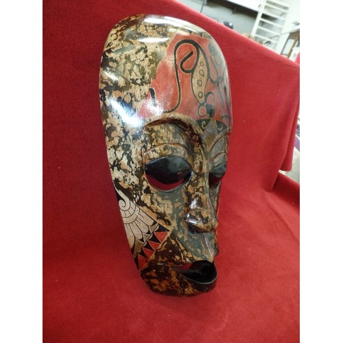 76 - DECORATED AFRICAN WOODEN MASK. LOVELY MUTED COLOURS, RUST, BROWN, BLACK. WALL HUNG. HIGH GLOSS.