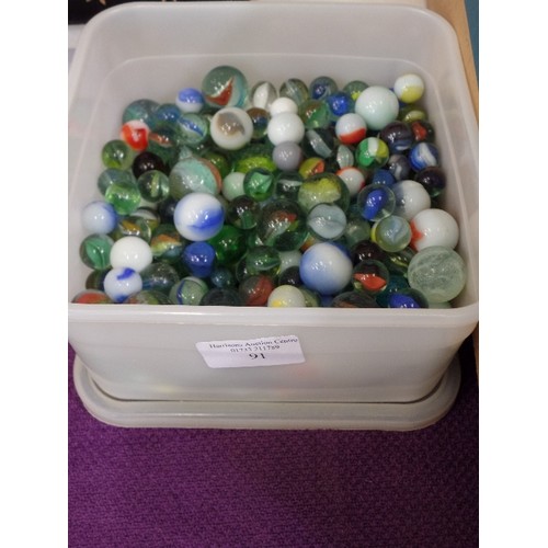 91 - TUB FULL OF GLASS MARBLES.