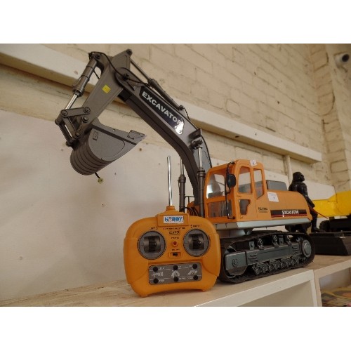 97 - LARGE HOBBY ENGINE 0803 REMOTE CONTROL EXCAVATOR. WITH CHARGER AND CONTROLS. WORKING AT TIME OF LOTT... 