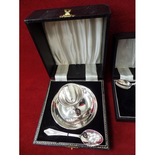 107 - 2 X SILVER-PLATE CHRISTENING EGG-CUP GIFT SETS. ALSO A SET OF TEA-SPOONS. ORIGINAL BOXES.