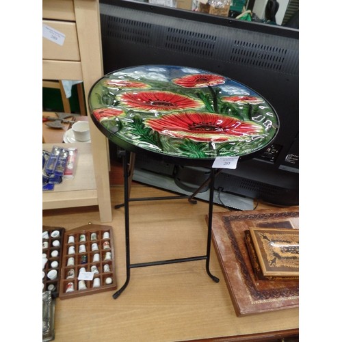 285 - SMALL FOLDING METAL TABLE, WITH LOVELY CIRCULAR GLASS POPPY DESIGN TOP.