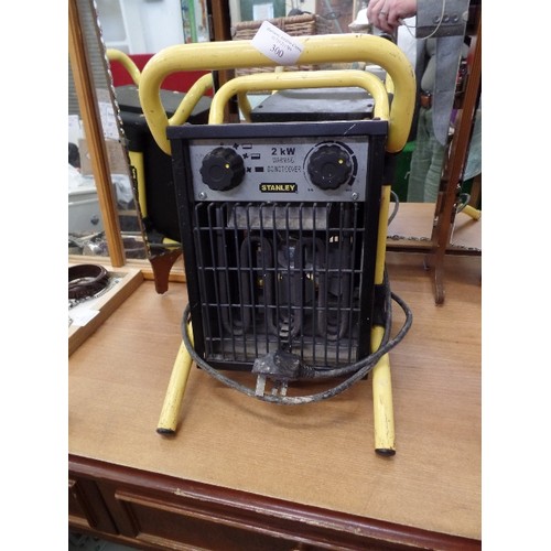 300 - STANLEY 2 KW ELECTRIC FAN HEATER. ON YELLOW CARRY STAND. WORKING