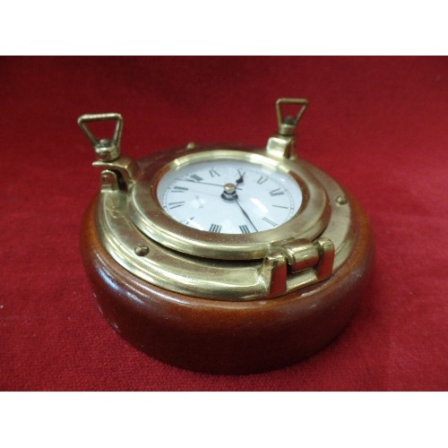 126 - SMALL QUARTZ WALL CLOCK IN THE STYLE OF A SHIPS PORTHOLE. BRASS WITH WOOD BASE.