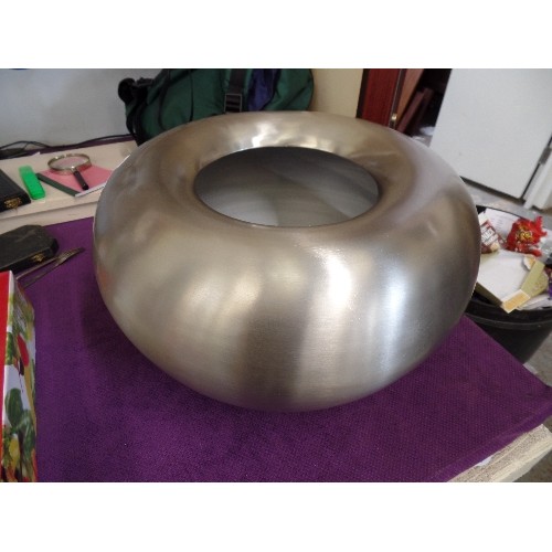 65 - LARGE BRUSHED STEEL CIRCULAR PLANTER. DENT IN 1 SIDE WHICH SHOULD HAMMER OUT.