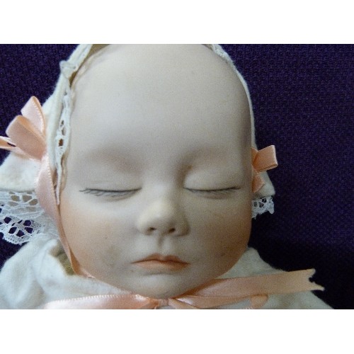 83 - VINTAGE JOYCE WOLF DOLL. PORCELAIN HEAD, SOFT HEAVY BODY & LIMBS. DRESSED IN NIGHTWEAR.