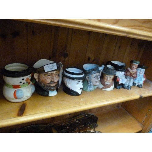 395 - COLLECTION OF 8 SMALL TOBY JUGS. INCLUDES WINSTON CHURCHILL, OLIVER TWIST, CHARLIE CHAPLIN, A PIRATE... 