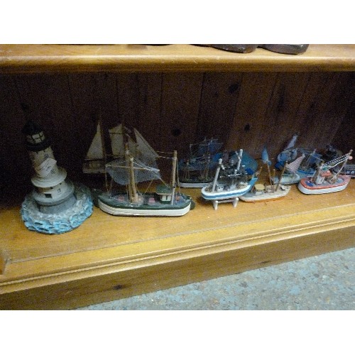 398 - COASTAL ORNAMENT COLLECTION OF A LIGHTHOUSE & 12 LITTLE WOODEN FISHING BOATS.