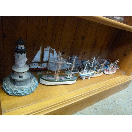 398 - COASTAL ORNAMENT COLLECTION OF A LIGHTHOUSE & 12 LITTLE WOODEN FISHING BOATS.