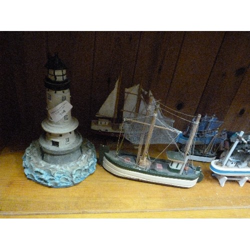 398 - COASTAL ORNAMENT COLLECTION OF A LIGHTHOUSE & 12 LITTLE WOODEN FISHING BOATS.