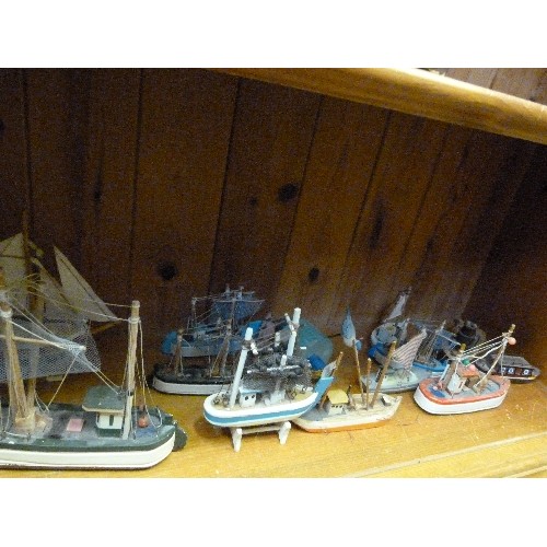 398 - COASTAL ORNAMENT COLLECTION OF A LIGHTHOUSE & 12 LITTLE WOODEN FISHING BOATS.