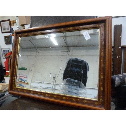 413 - BEVELLED WALL MIRROR WITH FLORAL WOODEN FRAME.