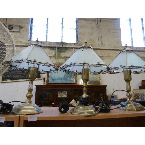 438 - THREE  BRUSHED BRASS TABLE LAMPS. WITH SIMPLE TIFFANY STYLE GLASS SHADES.