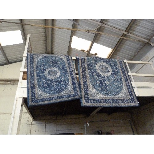 405 - 2 BLUE PATTERNED RUGS. A LARGE RECTANGULAR, AND A SMALLER MATCHING.