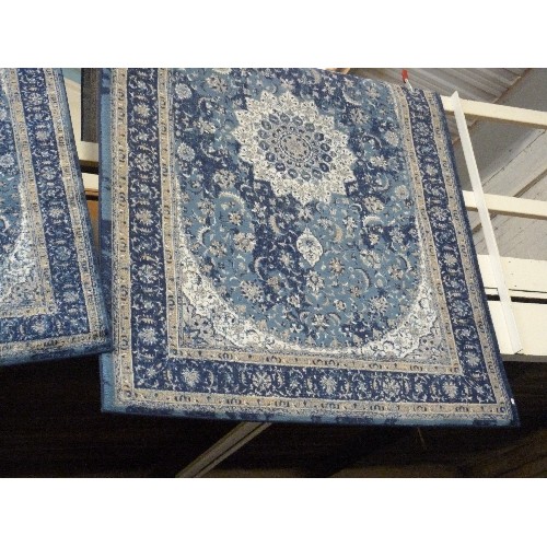 405 - 2 BLUE PATTERNED RUGS. A LARGE RECTANGULAR, AND A SMALLER MATCHING.