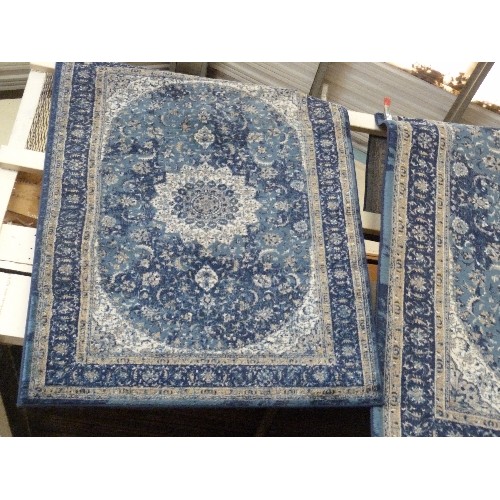 405 - 2 BLUE PATTERNED RUGS. A LARGE RECTANGULAR, AND A SMALLER MATCHING.