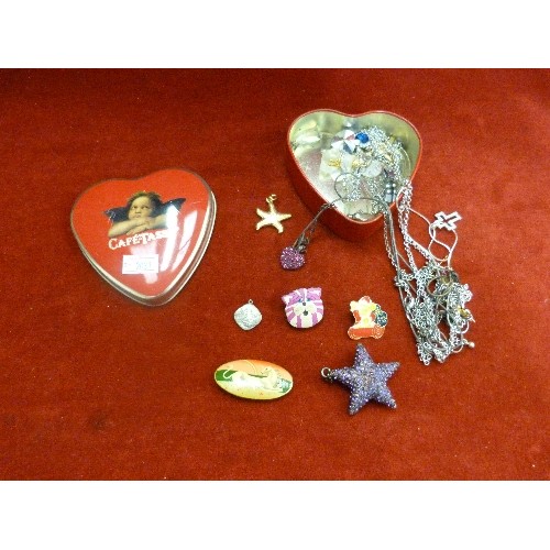 11 - CAFE TASSE CHERUB HEART TIN WITH MODERN COSTUME JEWELLERY CONTENTS. PURPLE STAR PENDANT, GLASS TEDDY... 