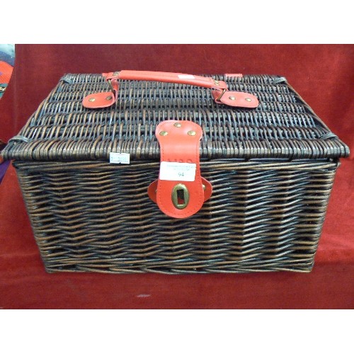 94 - SMALL M&S HAMPER. DARK BROWN WICKER WITH RED STRAPS ETC.