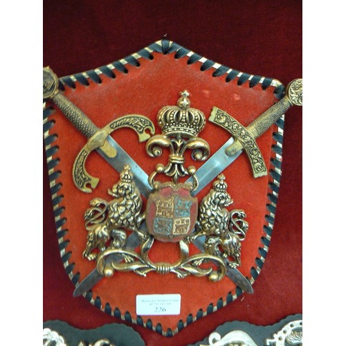 226 - PLASTIC COAT OF ARMS WALL PLAQUE, PLASTIC HORSE BRASSES ON STRAP, AND A LEATHER BELT.