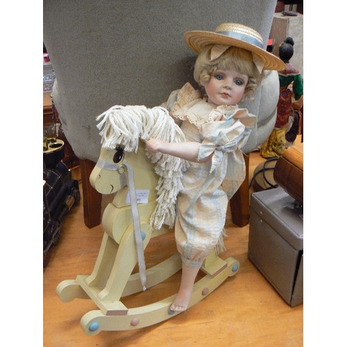 248 - PORCELAIN DOLL ON WOODEN ROCKING HORSE.