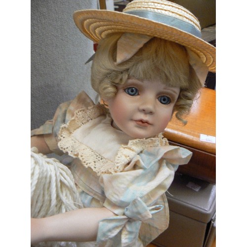 248 - PORCELAIN DOLL ON WOODEN ROCKING HORSE.