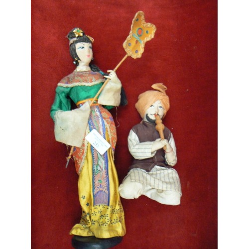 253 - TRADITIONALLY DRESSED INDIAN DOLLS. SNAKE CHARMER & WOMAN WITH SUN SHIELD.