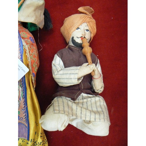 253 - TRADITIONALLY DRESSED INDIAN DOLLS. SNAKE CHARMER & WOMAN WITH SUN SHIELD.