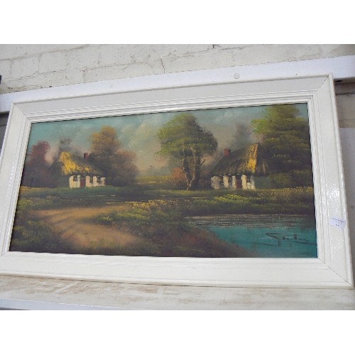 157 - SIGNED OIL ON CANVAS.  THATCHED COTTAGES BY A LAKE. [UNSURE OF ARTIST] IVORY PAINTED FRAME.