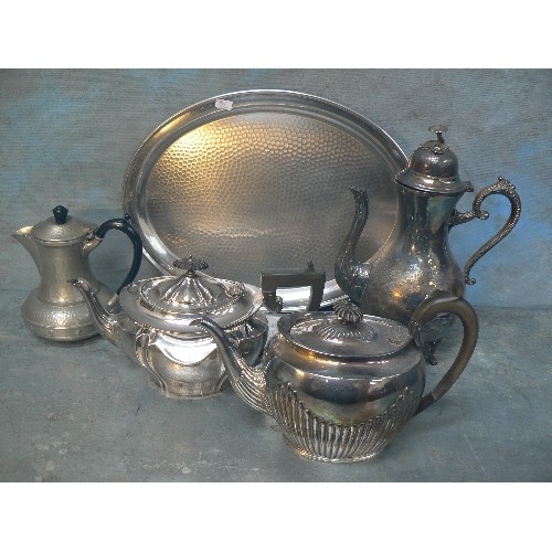 141 - ANTIQUE AND VINTAGE PLATED WARES ON A TRAY. INCLUDES COFFEE POT, TWO TEAPOTS AND A PEWTER HOT WATER ... 